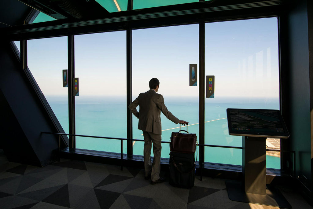 Businessman carrying stylish black suitcase for business trp