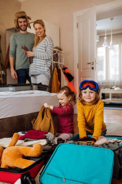 Happy family packing suitcases for their vacation